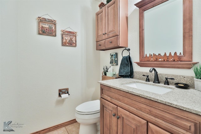 bathroom featuring tile floors, toilet, and vanity