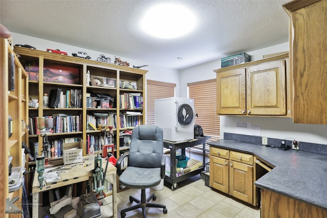 tiled home office with a textured ceiling