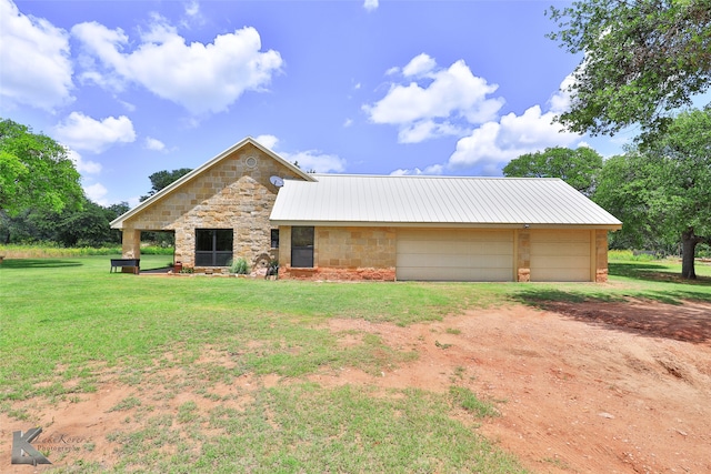 view of front of property with a garage and a front yard