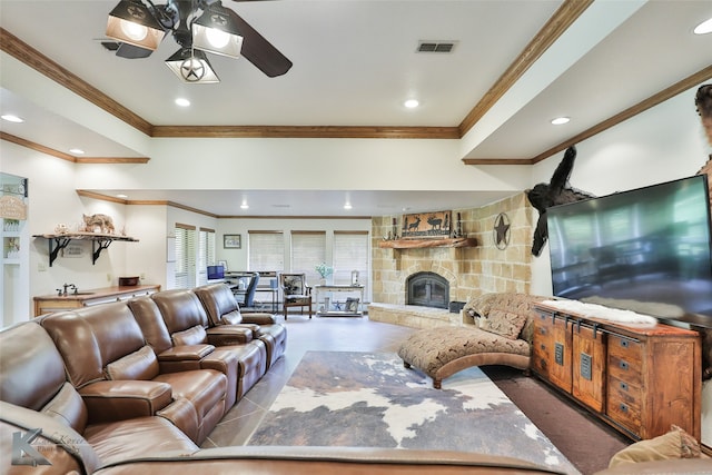 living room with crown molding, ceiling fan, a fireplace, and tile flooring