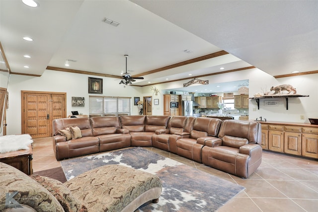 tiled living room featuring crown molding and ceiling fan