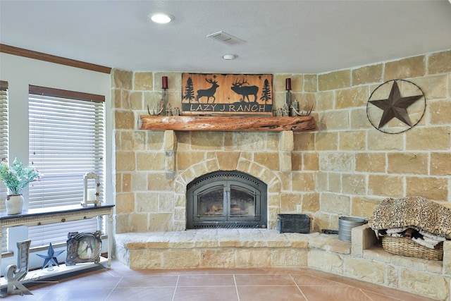 details featuring tile floors, ornamental molding, and a fireplace