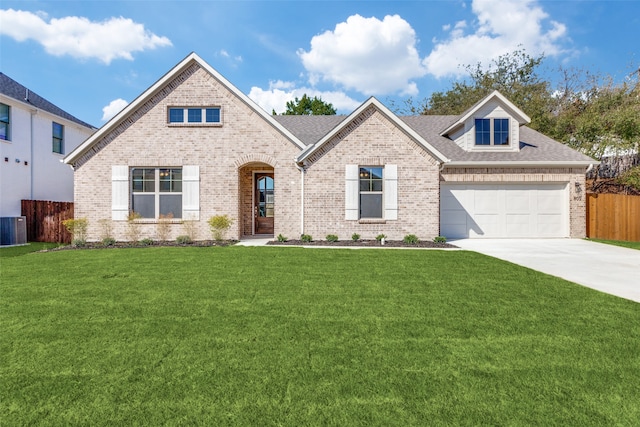 view of front of house featuring driveway, brick siding, a front yard, and fence