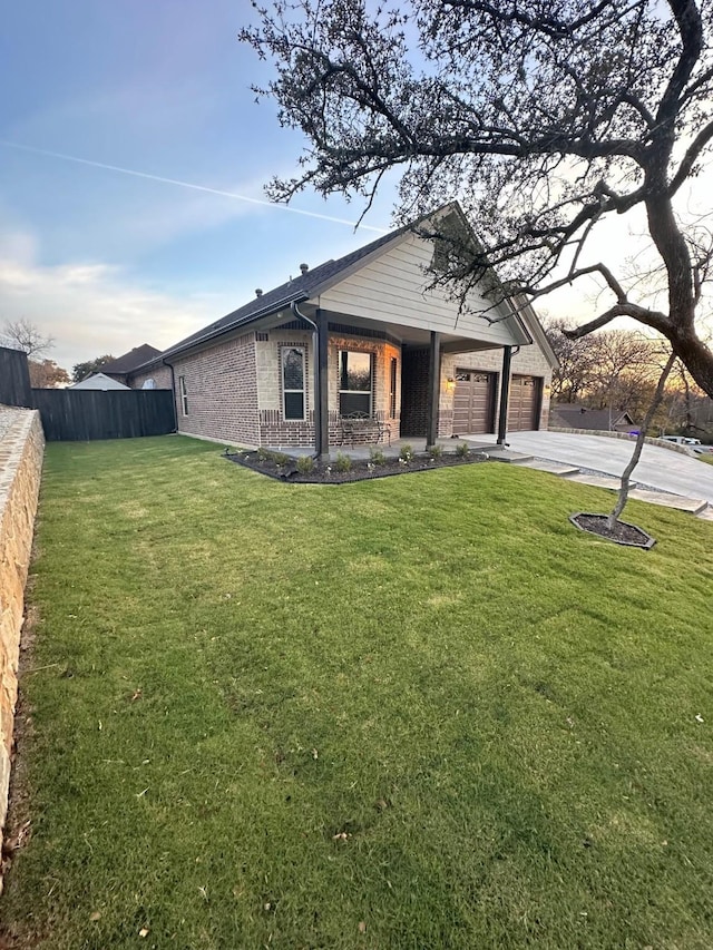 view of front of home with a front yard and a garage