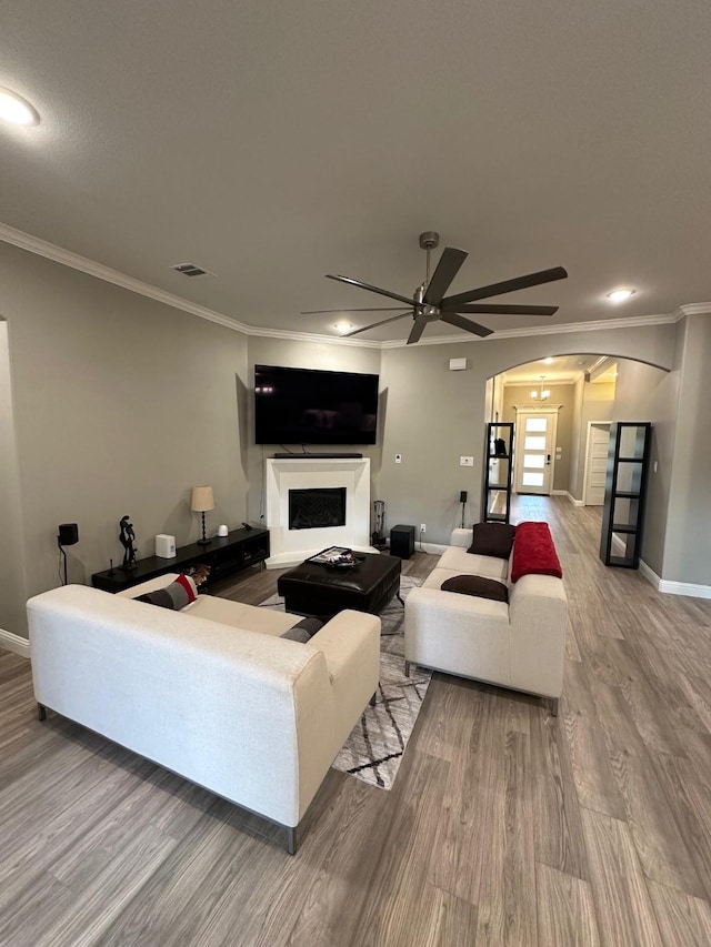 living room featuring ceiling fan, crown molding, and hardwood / wood-style floors