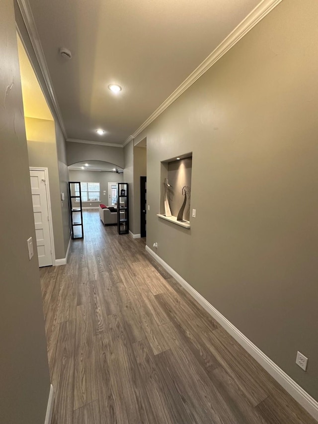 hall with hardwood / wood-style flooring and ornamental molding