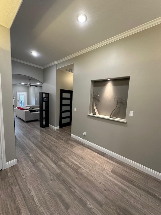 interior space featuring hardwood / wood-style floors, ceiling fan, and ornamental molding