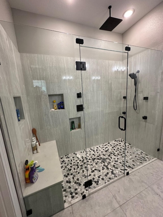 bathroom featuring a shower with door