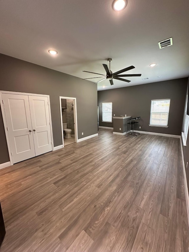 unfurnished living room featuring hardwood / wood-style floors and ceiling fan