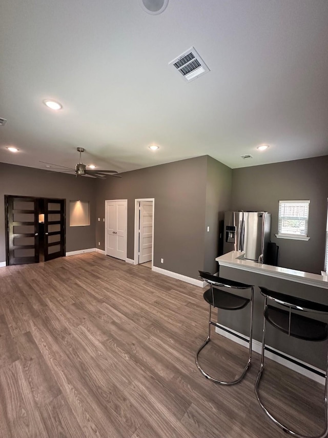 living room with ceiling fan and hardwood / wood-style floors