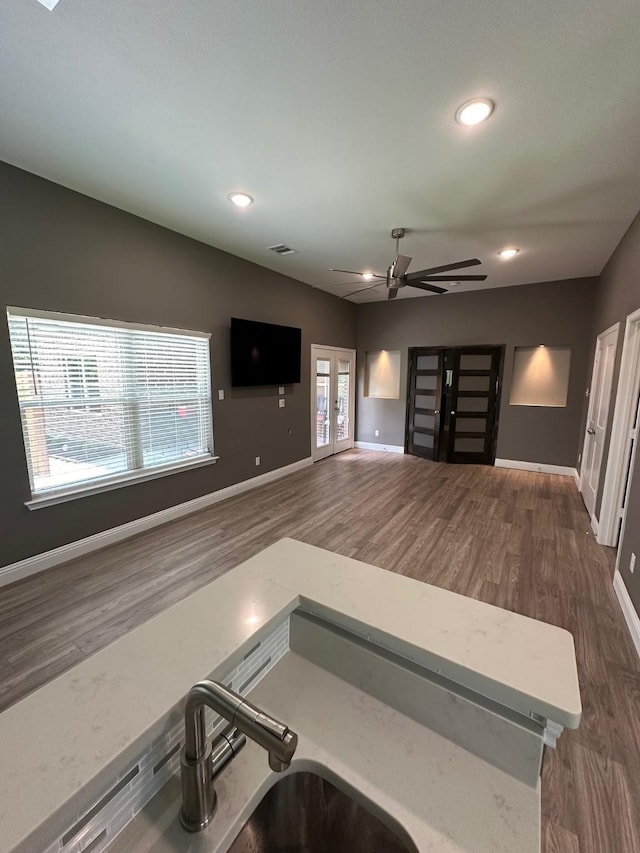 kitchen with sink, french doors, dark hardwood / wood-style flooring, and ceiling fan