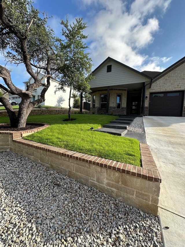 view of front facade with a front yard and a garage