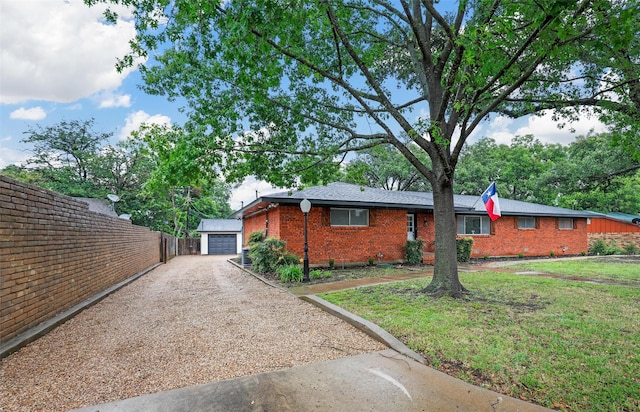 view of home's exterior with a lawn, a garage, and an outbuilding