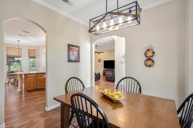 dining area featuring wood-type flooring, ceiling fan, and ornamental molding