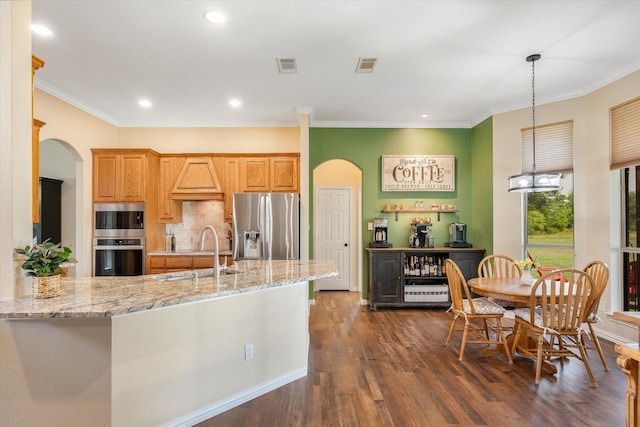 kitchen featuring sink, crown molding, light stone counters, dark hardwood / wood-style flooring, and stainless steel appliances