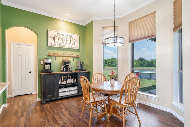 dining room with ornamental molding and dark wood-type flooring