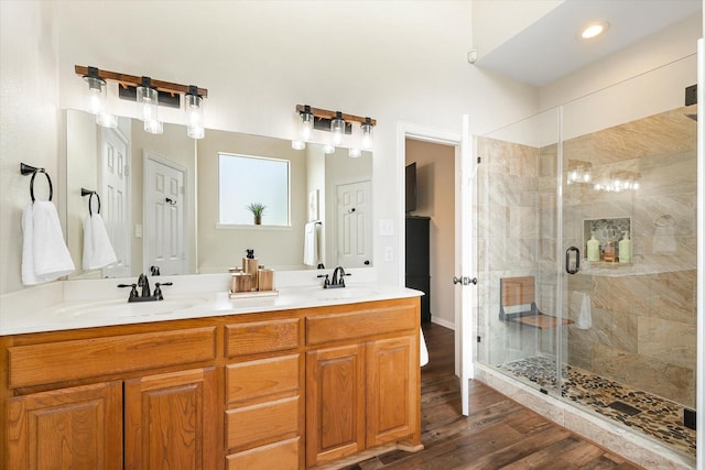 bathroom with vanity, wood-type flooring, and a shower with shower door