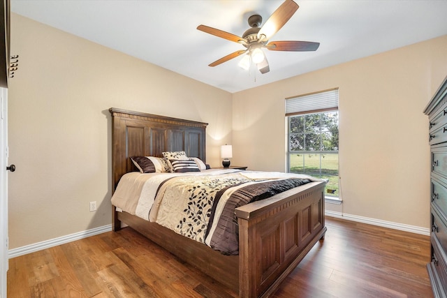 bedroom featuring ceiling fan and dark wood-type flooring