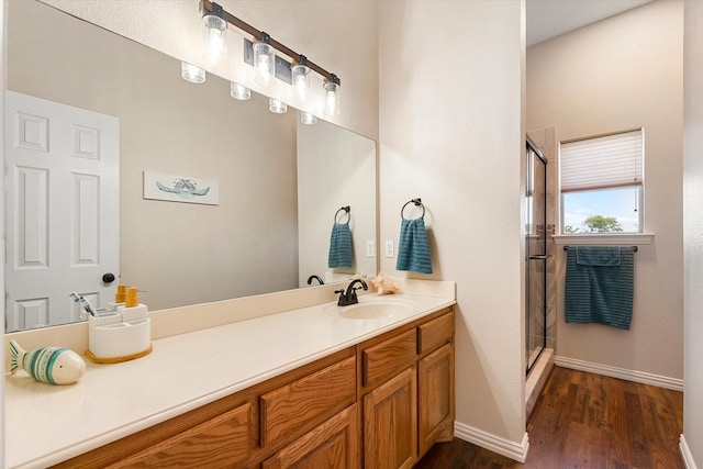 bathroom with hardwood / wood-style floors, vanity, and walk in shower