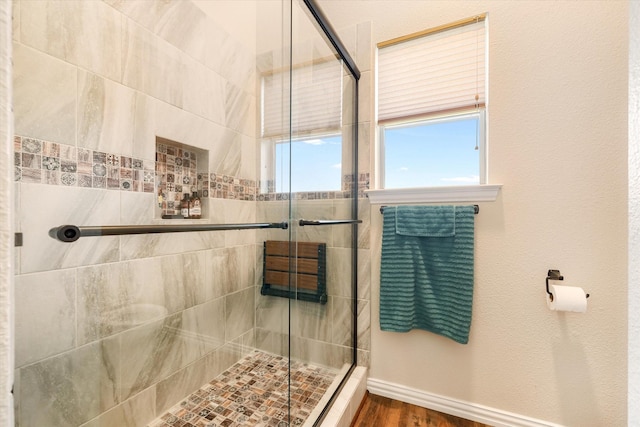 bathroom featuring an enclosed shower and wood-type flooring