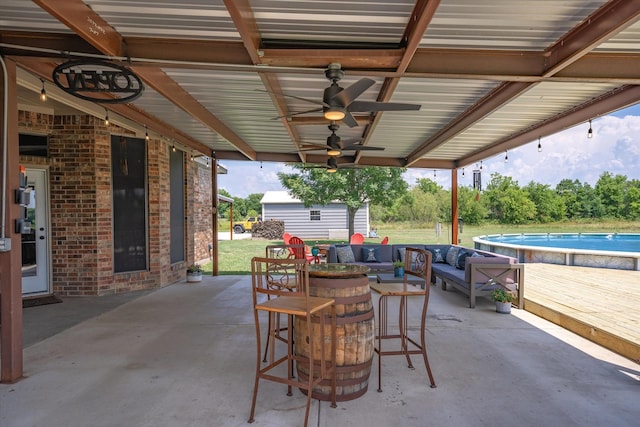 view of patio / terrace with an outdoor living space and a shed