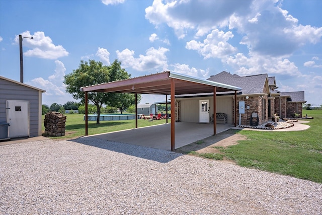 view of parking with a yard and a carport