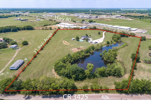 drone / aerial view featuring a water view and a rural view