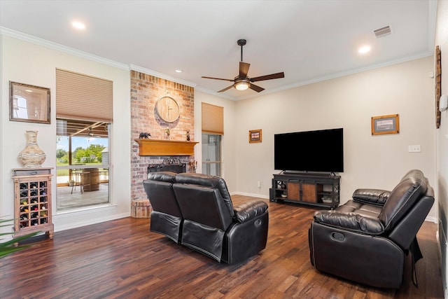 living room with dark hardwood / wood-style floors, a brick fireplace, ceiling fan, and crown molding