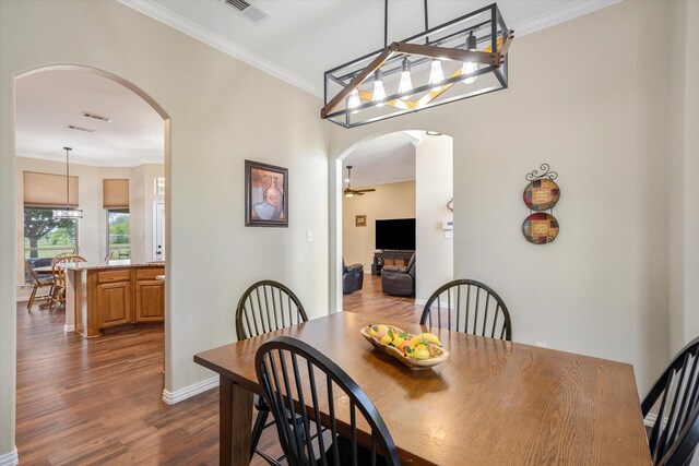 dining area featuring crown molding and dark hardwood / wood-style flooring