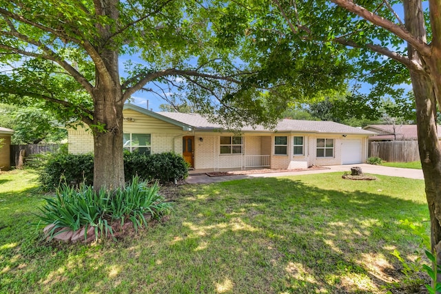 rear view of property featuring a yard and a garage