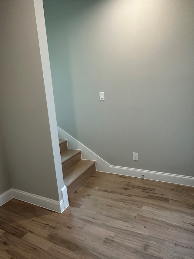 stairs featuring wood-type flooring