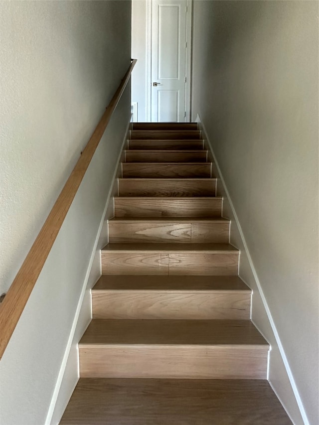 stairs with hardwood / wood-style flooring