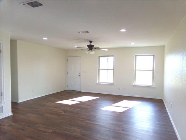 spare room with dark hardwood / wood-style floors and ceiling fan