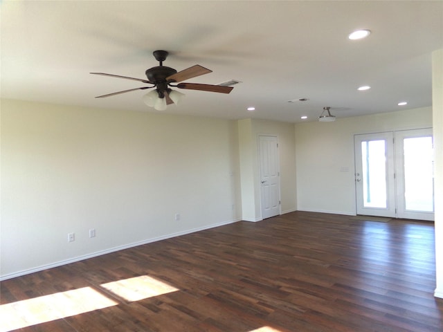 spare room with dark wood-type flooring and ceiling fan