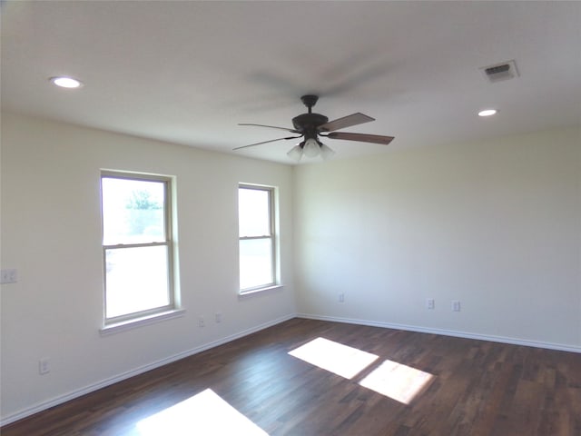 spare room with ceiling fan and dark hardwood / wood-style flooring