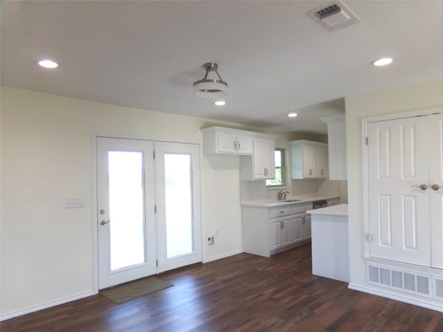 kitchen featuring dark hardwood / wood-style floors, sink, and white cabinets