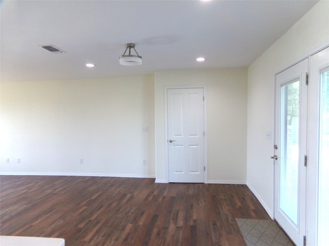 unfurnished room with dark hardwood / wood-style flooring