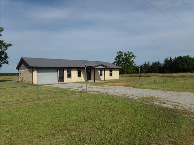 view of front of property with a garage and a front lawn