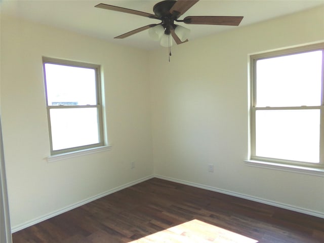 spare room with ceiling fan and dark hardwood / wood-style flooring