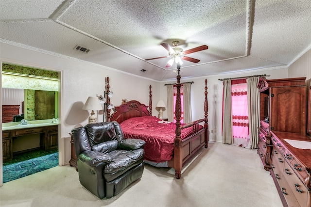 carpeted bedroom with ornamental molding, ceiling fan, ensuite bathroom, and a textured ceiling