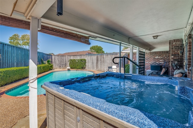 view of pool featuring a hot tub