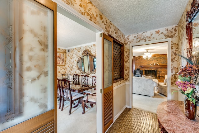 hall featuring a textured ceiling and carpet flooring