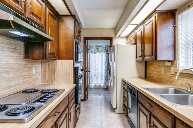 kitchen featuring black appliances, decorative backsplash, and plenty of natural light