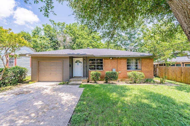 ranch-style house featuring a front lawn and a garage