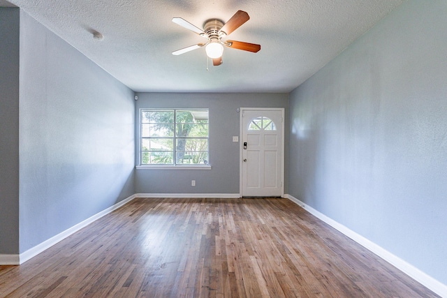 entrance foyer with wood-type flooring, a textured ceiling, and ceiling fan