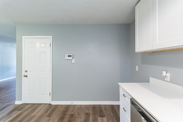 kitchen with white cabinetry, stainless steel dishwasher, and dark hardwood / wood-style floors