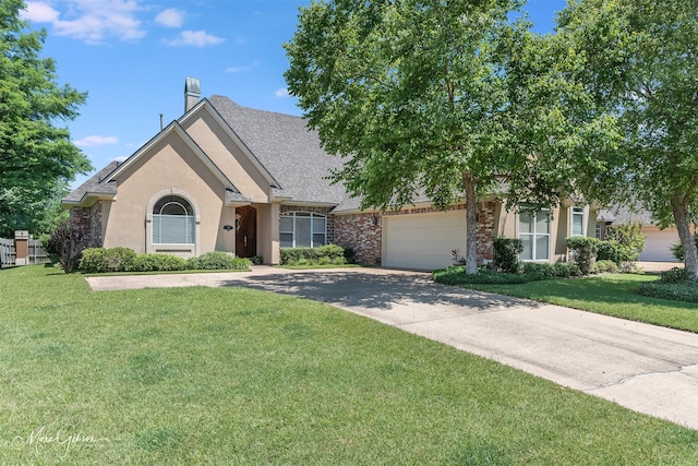 view of front of home with a front lawn and a garage