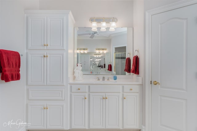 bathroom featuring ceiling fan, vanity, and ornamental molding