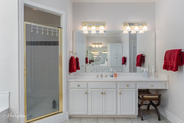 bathroom featuring a shower with door, vanity, and tile patterned flooring