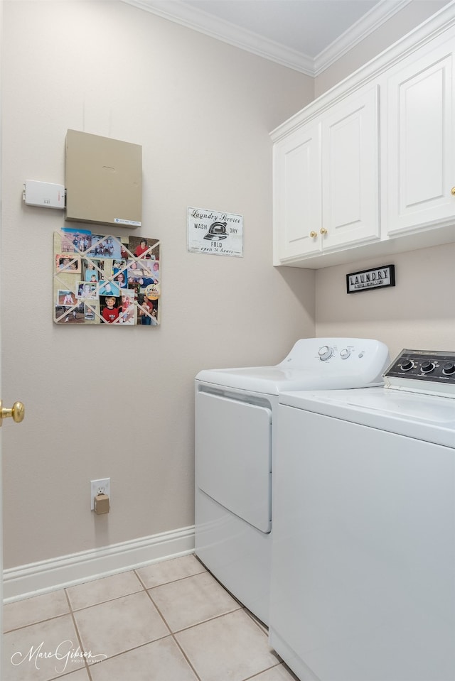 washroom with cabinets, light tile patterned floors, washer and dryer, and crown molding